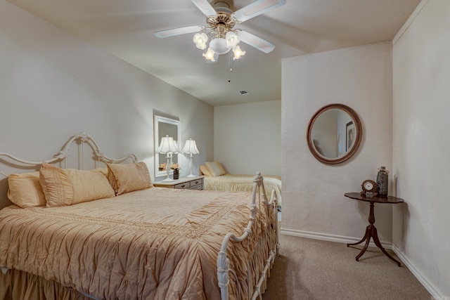 bedroom with carpet floors, visible vents, baseboards, and ceiling fan