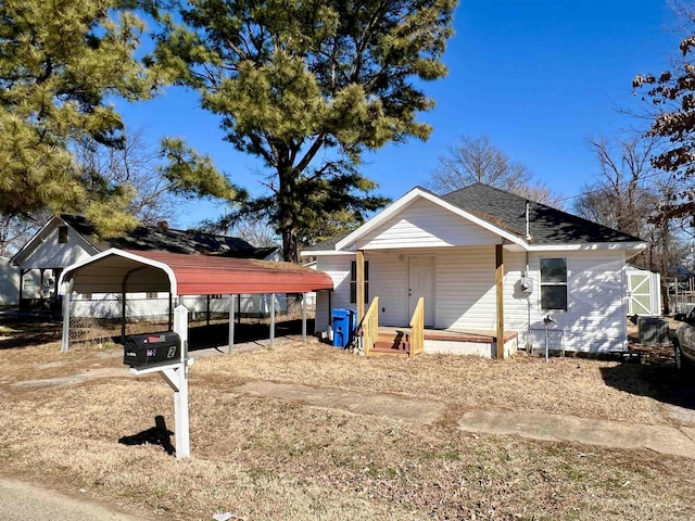 view of side of property with a carport and roof with shingles