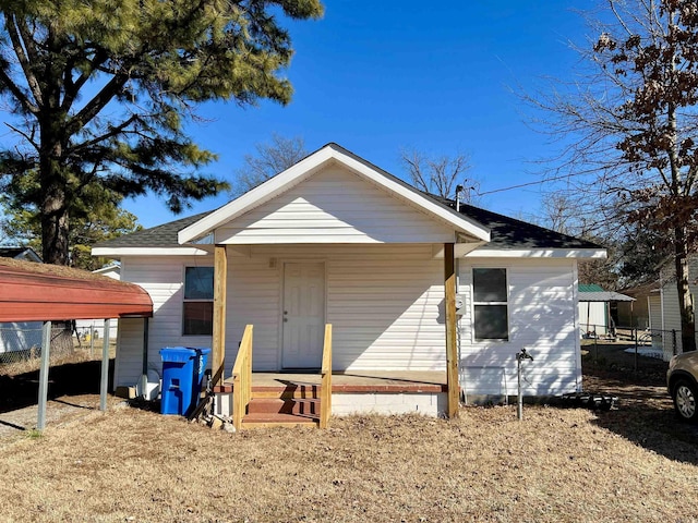 back of house with a shingled roof