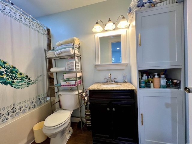 full bath with toilet, shower / tub combo, wood finished floors, and vanity