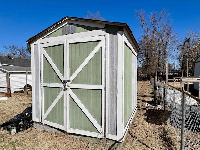 view of shed with fence