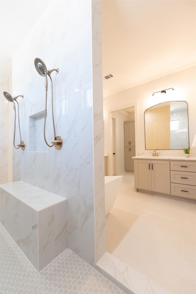 full bathroom with a freestanding tub, a marble finish shower, visible vents, and vanity