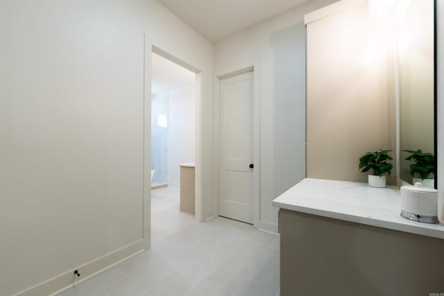 hallway with light floors and baseboards