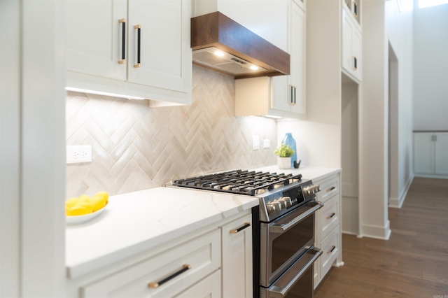 kitchen featuring premium range hood, dark wood-style flooring, white cabinetry, high end stainless steel range oven, and tasteful backsplash