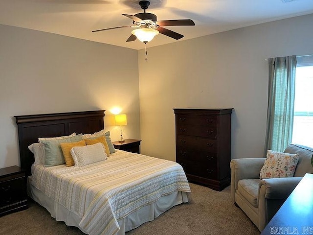 carpeted bedroom with visible vents and a ceiling fan