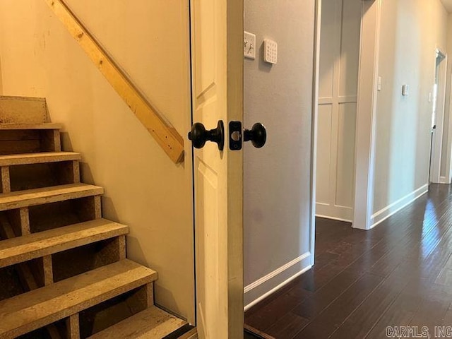 staircase with baseboards and wood finished floors