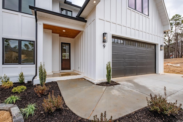 doorway to property featuring board and batten siding and concrete driveway