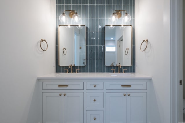 full bathroom featuring double vanity, a sink, and decorative backsplash