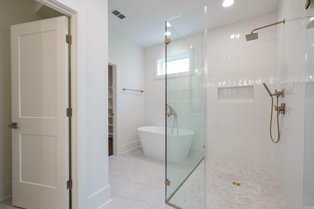 full bathroom featuring a walk in shower, marble finish floor, a soaking tub, and visible vents