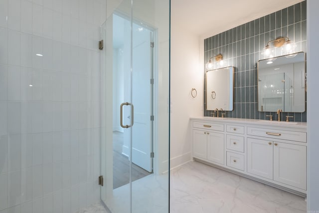 full bathroom featuring a sink, tile walls, marble finish floor, double vanity, and a stall shower