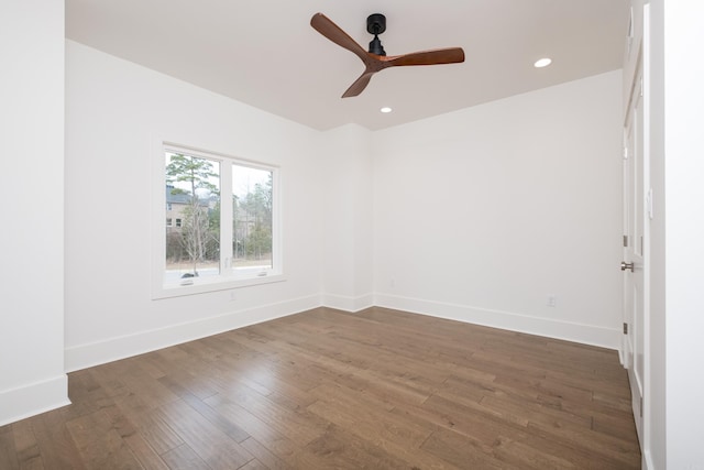 spare room with recessed lighting, dark wood-style flooring, ceiling fan, and baseboards