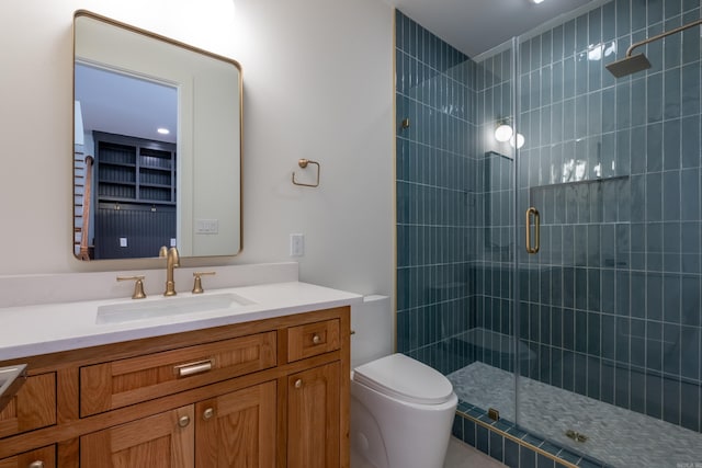 full bath featuring toilet, a shower stall, and vanity