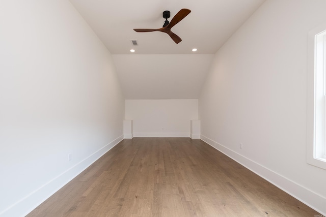 bonus room featuring a ceiling fan, visible vents, baseboards, and wood finished floors