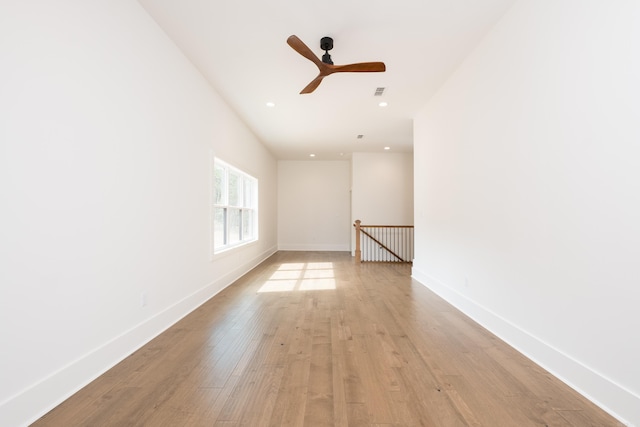 empty room featuring recessed lighting, baseboards, visible vents, and light wood finished floors