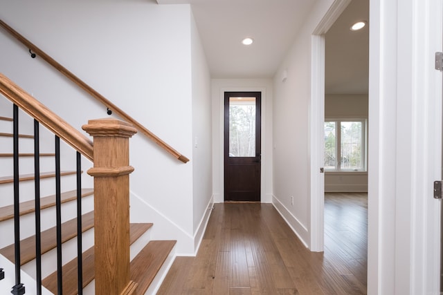 entrance foyer featuring stairway, baseboards, wood finished floors, and recessed lighting