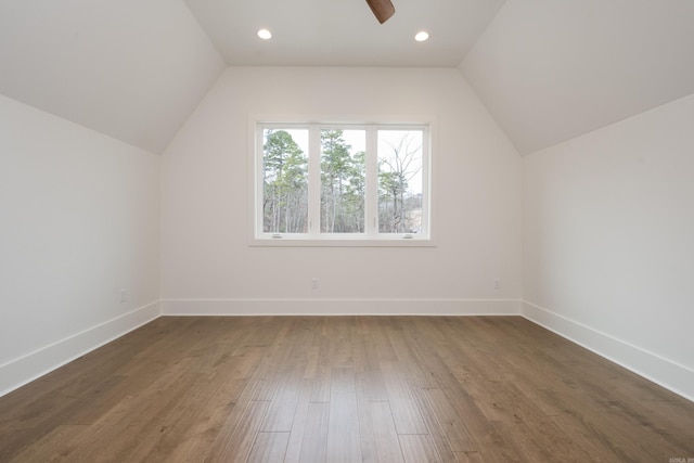 additional living space featuring lofted ceiling, ceiling fan, wood finished floors, and baseboards