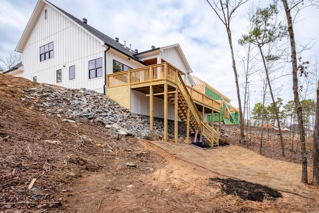 back of property with stairs and a wooden deck