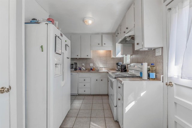 kitchen featuring light tile patterned floors, under cabinet range hood, white appliances, a sink, and decorative backsplash