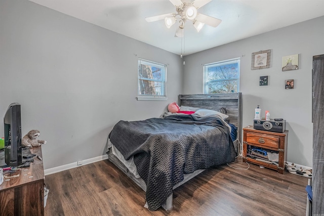 bedroom featuring ceiling fan, baseboards, and wood finished floors