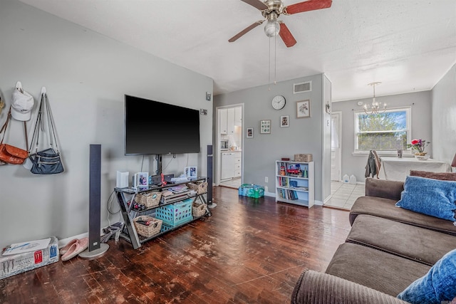 living room with baseboards, visible vents, wood finished floors, a textured ceiling, and ceiling fan with notable chandelier