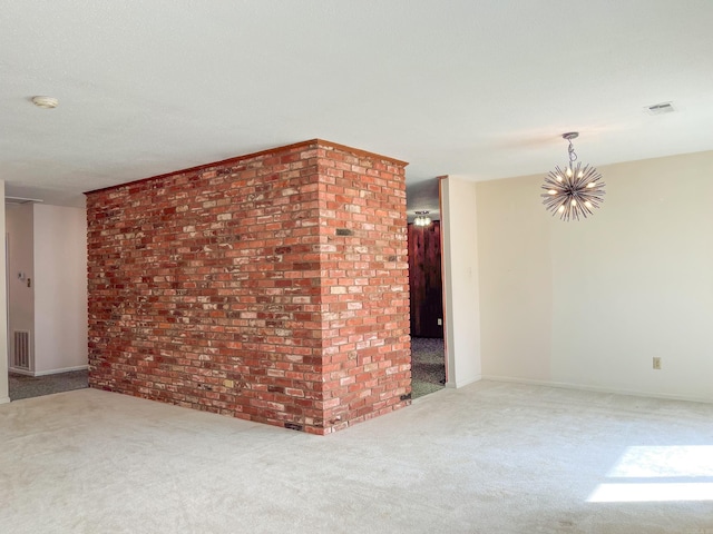 unfurnished room featuring a chandelier, carpet flooring, visible vents, and baseboards