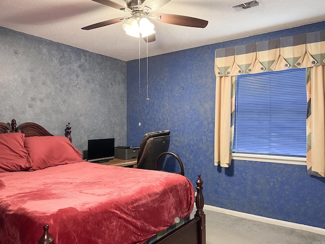 carpeted bedroom with a ceiling fan, visible vents, baseboards, and wallpapered walls