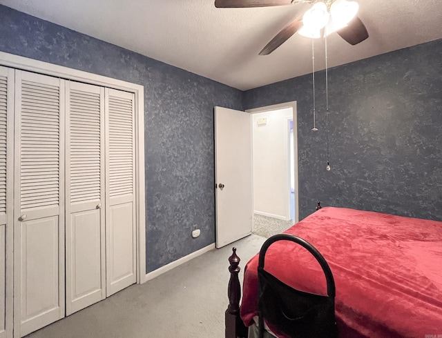 bedroom featuring a ceiling fan, carpet, a closet, and baseboards