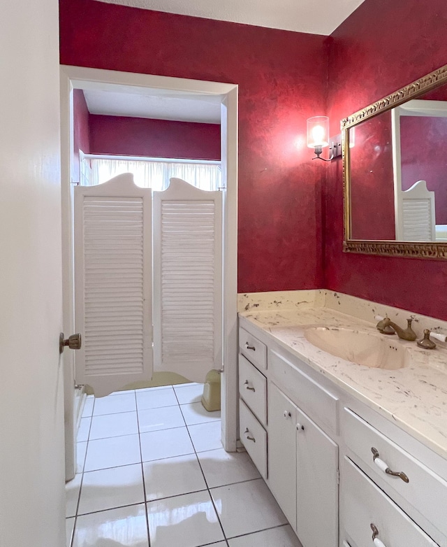 bathroom with tile patterned flooring and vanity