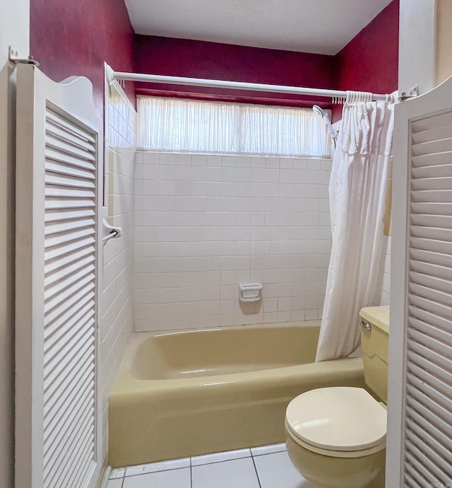 full bathroom featuring shower / bath combo, tile patterned flooring, and toilet