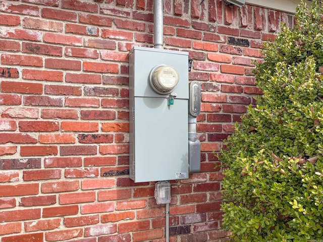 details featuring brick siding and electric meter