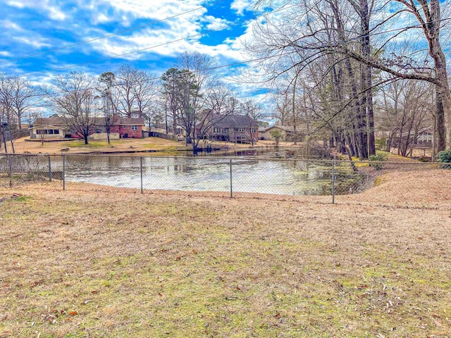 view of yard with a water view and fence