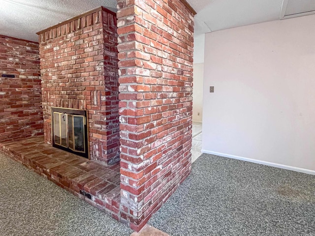 unfurnished living room featuring a textured ceiling, a brick fireplace, carpet flooring, and baseboards