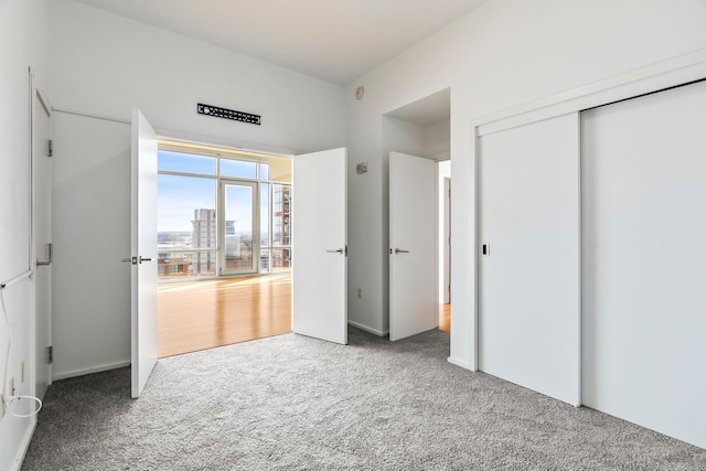 unfurnished bedroom featuring carpet floors and a closet