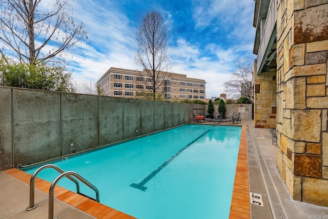 view of swimming pool featuring fence and a fenced in pool