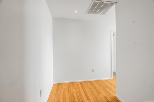 spare room with recessed lighting, baseboards, visible vents, and light wood finished floors