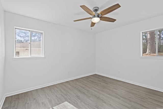 spare room featuring ceiling fan, wood finished floors, and baseboards