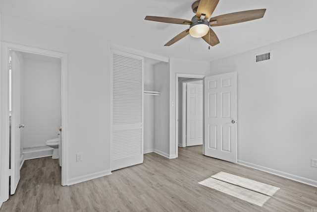 unfurnished bedroom featuring a closet, visible vents, baseboards, and wood finished floors