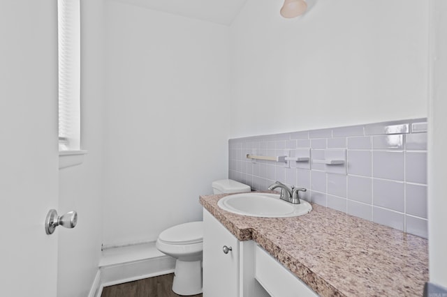 bathroom featuring toilet, wood finished floors, and vanity