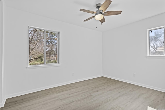 unfurnished room featuring a ceiling fan, baseboards, and wood finished floors