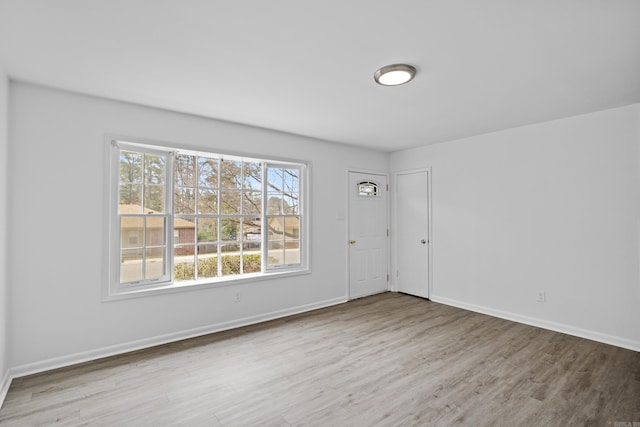 unfurnished room with wood finished floors and baseboards