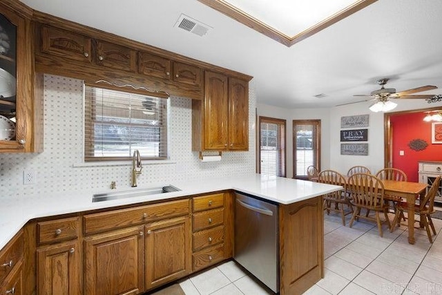 kitchen with a wealth of natural light, visible vents, dishwasher, and a sink