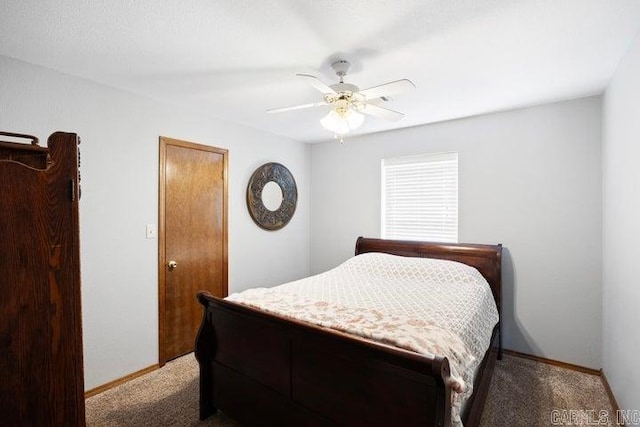 bedroom with a ceiling fan, carpet, and baseboards