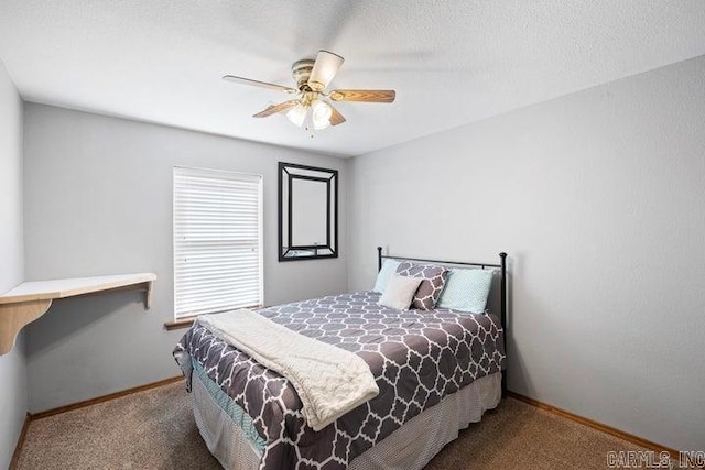 carpeted bedroom with a ceiling fan, a textured ceiling, and baseboards