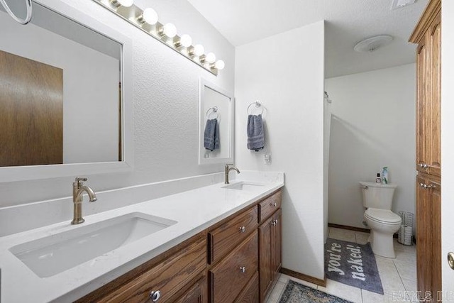 full bathroom featuring tile patterned flooring, a sink, toilet, and double vanity