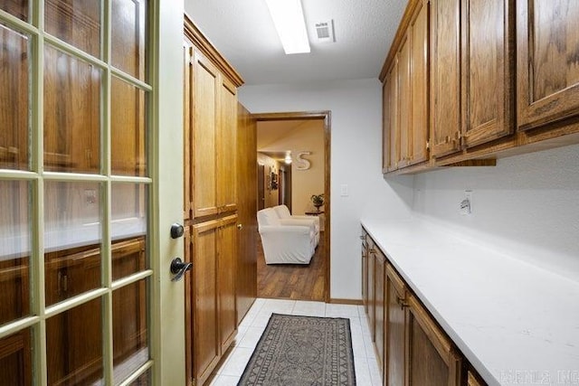 interior space with visible vents and light tile patterned floors