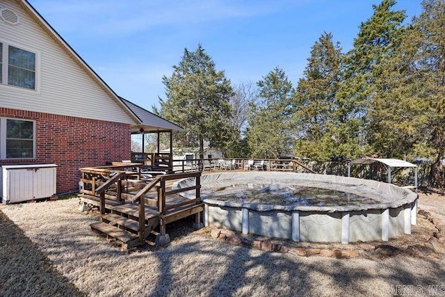 exterior space with a covered pool and a wooden deck