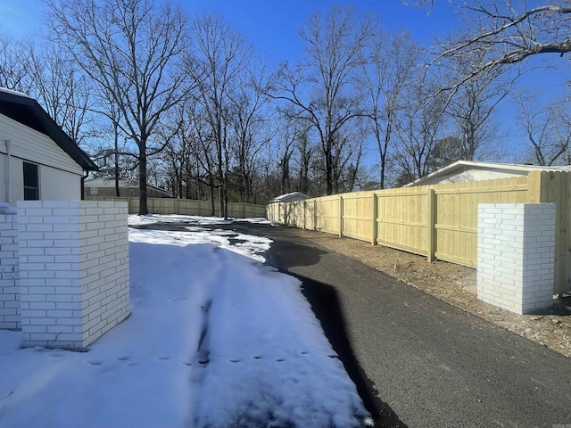 yard covered in snow featuring a fenced backyard