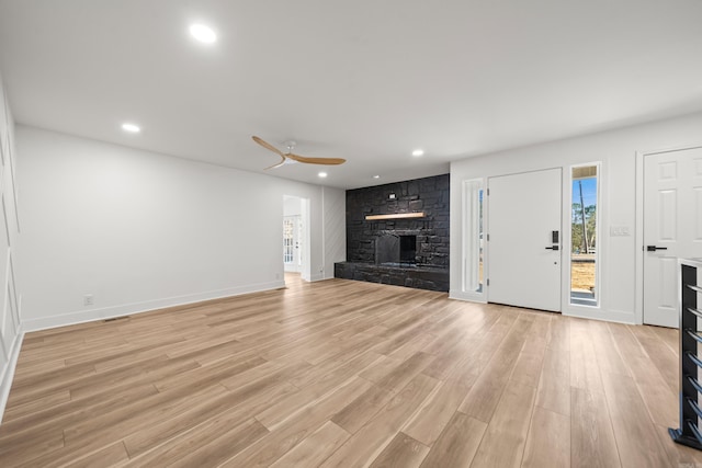 unfurnished living room featuring a fireplace, recessed lighting, light wood-style flooring, ceiling fan, and baseboards