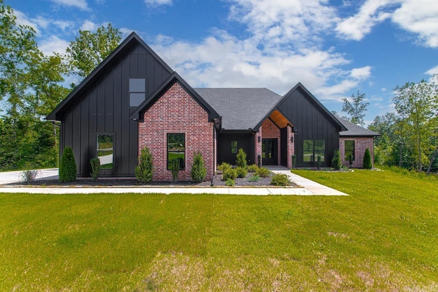 modern inspired farmhouse featuring roof with shingles, a front lawn, board and batten siding, and brick siding