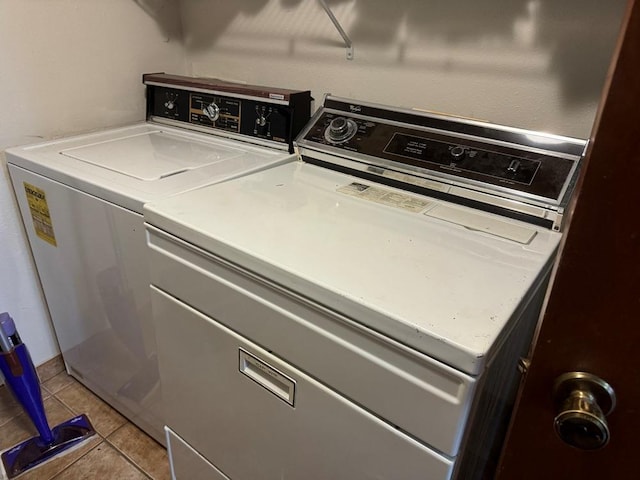 washroom featuring light tile patterned floors, laundry area, and independent washer and dryer